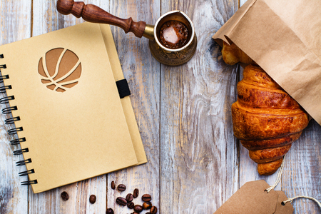 Morning coffee and fresh croissant on wooden table. Top view. Cozy breakfast. Flat lay styleの写真素材