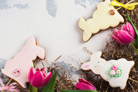 Easter bunnies with flowers and quail eggs on white background. Space for textの写真素材