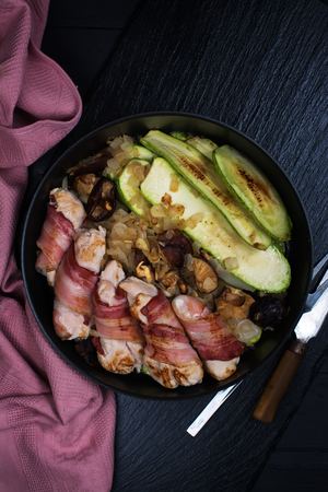 Grilled meat rolls wrapped in strips of bacon and marrow slices and shiitake mushrooms. Top view. Space for textの写真素材