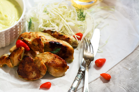 Roasted chicken steaks with mashed vegetable puree and cabbage salad. Selective focus. Space for textの写真素材