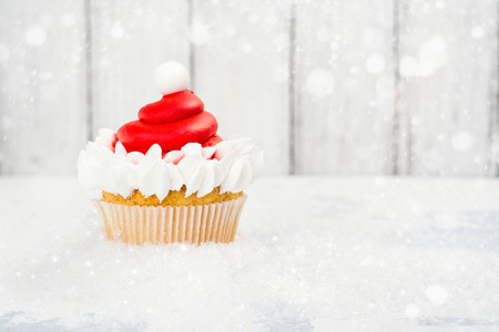 Santa Claus red hat cupcake. Delicious gift for Christmas. Space for text. Selective focusの写真素材