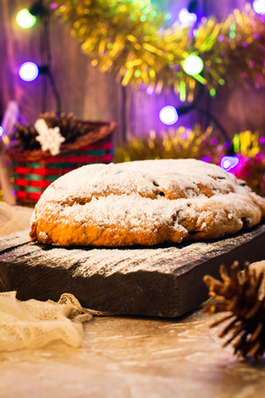 Traditional German Christmas stollen over festive background. Selective focus. Toned imageの写真素材