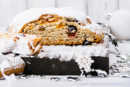 Traditional German Christmas stollen over white background. Selective focus
