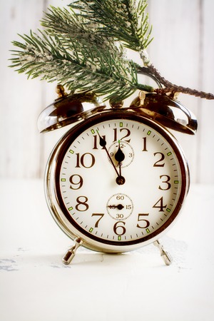Retro alarm o'clock showing five minutes to midnight. Xmas or new year concept. Selective focus. Space for textの写真素材
