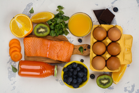 Healthy food good for eyes over white table. Productis fos excellent vision. Space for textの写真素材