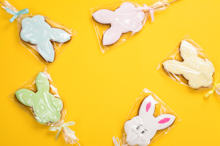 Easter cookies over yellow background. Funny bunnies. Space for textの写真素材