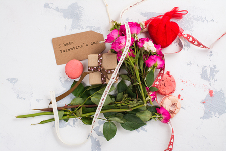 After party mess with flowers, gift box, cookies and decorative hearts. Top view. Space for textの写真素材