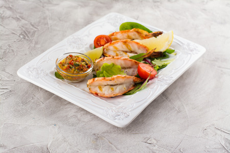 Grilled tiger shrimps with vegetables and spicy sauceの写真素材