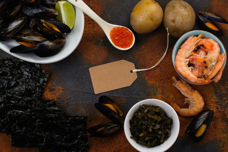 Food rich of iodine. Natural sources - mussels, baked, pototo, shrimps, red caviar, seaweed. Space for textの写真素材