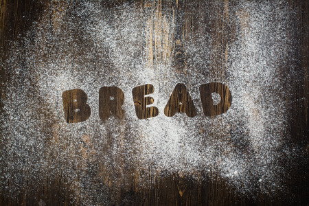 I love bake concept. Rolling pin, kitchen towel and flour on wooden tableの写真素材