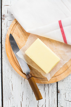 Butter stick on wooden board. Baking or cooking conceptの写真素材