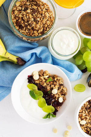 Tasty breakfast with granola, yogurt, coffee, fruits and berries. Selective focusの写真素材