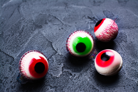 Funny halloween treat - jelly eyeballs on dark background. Copy spaceの写真素材
