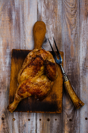 Roasted chicken with pita bread, tomato sauce and fresh raw vegetables on wooden tableの写真素材