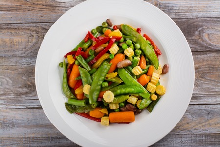 Stir fry vegetables on white plate. Copy space. Flat lay styleの写真素材