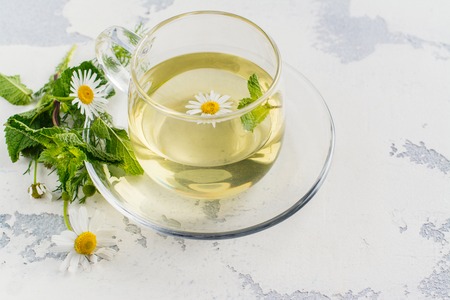 Herbal tea with herbs and flowers in a glass tea pot. Copy spaceの写真素材