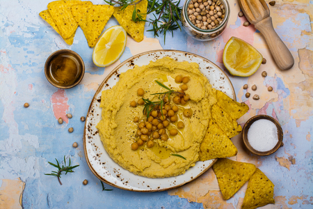 Traditional hummus and ingredients on stone table. Copy spaceの写真素材