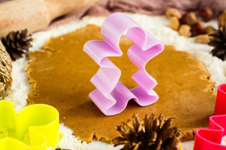 Christmas baking background with gingerbread man cutters and decorations