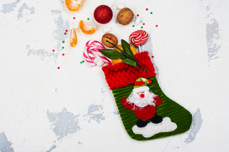 Christmas sock full of holiday gifts and sweets. Xmas greeting card. Copy spaceの写真素材