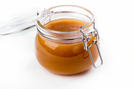 Homemade salted caramel sauce in a glass jarの写真素材
