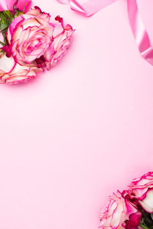 Beautiful pink rose, decorative confetti hearts and pink ribbon on pink Valentines day backgroundの写真素材