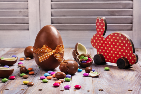 Easter chocolate eggs and decorative wooden bunnyの写真素材