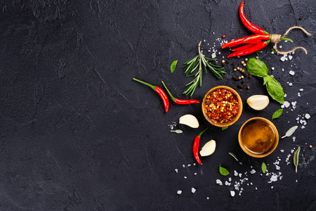 Fresh herbs and spices on black stone tableの写真素材