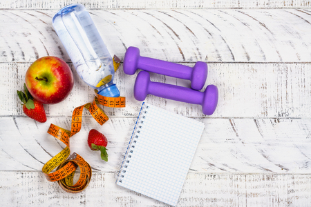 Apple, bottle of water and measuring tape on white backgroundの写真素材