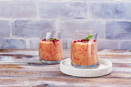Healthy refreshing pink smoothie with , red oranges, cowberry and branの写真素材