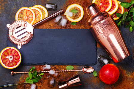 Bar accessories, drink tools and cocktail ingredients on rusty stone table. Flat lay styleの写真素材