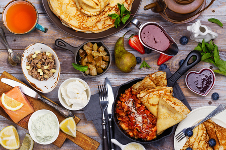 Colorful, tasty and savory breakfast with crepes and different fillings and saucesの写真素材