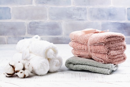 SPA or welness concept with cotton towels, soap and sea saltの写真素材