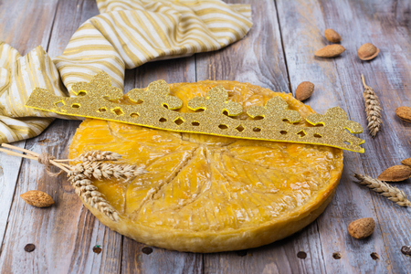 Homemade Galette des Rois cake with handmade kings crown. Traditional French Epiphany cake with ground almondの写真素材