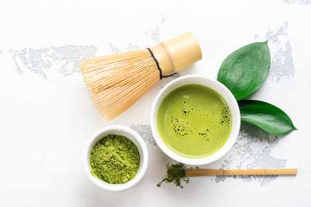 Green matcha tea drink and tea accessories on white backgroundの写真素材