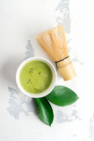 Green matcha tea drink and tea accessories on white backgroundの写真素材