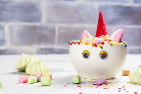 Unicorn cocoa with colorful sprinkles, marshmallow and cookiesの写真素材