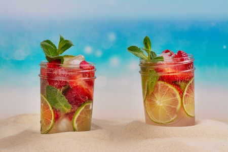 Strawberry mojito on summer sandy beachの写真素材