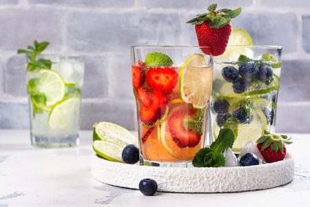 Summer homemade fruit and berries lemonade. Mojito, lemonade and sangria in tall glasses. Copy spaceの写真素材