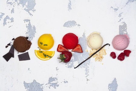 Chocolate, orange, strawberry, vanilla and raspberry ice cream scoopsの写真素材