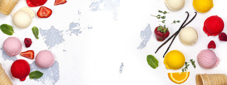 Orange, vanilla, raspberry and strawberry ice cream scoops on white backgroundの写真素材