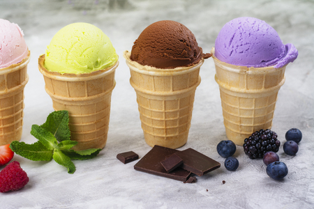 Assortment of natural ice cream - strawberry, chocolate, orange, blueberry and mintの写真素材