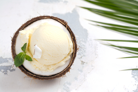Coconut ice cream scoops in halves of coconut shellの写真素材