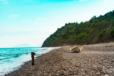 Lonely boat on the sunset beachの写真素材