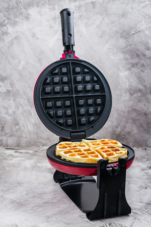 Waffles in an iron waffle makerの写真素材