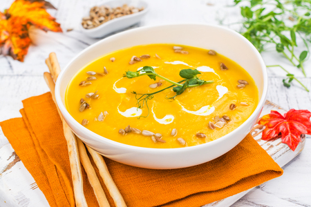 Pumpkin soup on autumn backgroundの写真素材