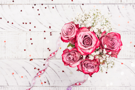 Pink roses in a white pitcherの写真素材