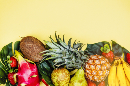 Tropical fruits on yellowの写真素材