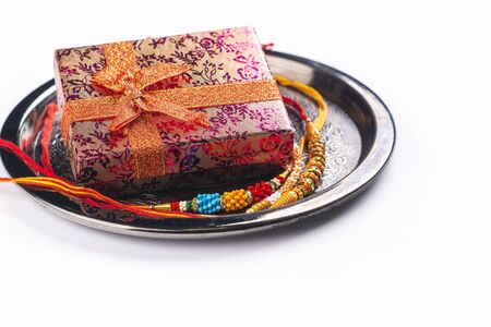 Indian rakhi bracelet and gift box on whiteの写真素材