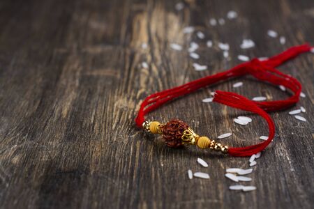 Indian rakhi bracelet on wooden backgroundの写真素材
