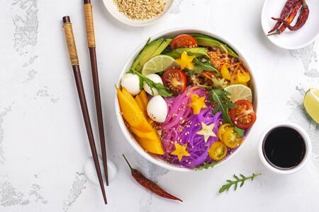 Rainbow noodle with vegetables. Unicorn buddha bowl with colorful pasta, fruits and vegetables. Healthy nutrition food. Copy spaceの写真素材